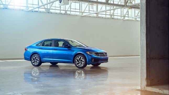 A photo of a blue VW Jetta in a warehouse. 