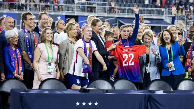 Members of U.S. Soccer and the U.S. Women’s National Team Players Association hold up an Equal Pay jersey after signing a collective bargaining agreement signifying equal pay between the men’s and women’s national soccer teams at Audi Field on September 06, 2022, in Washington, D.C.