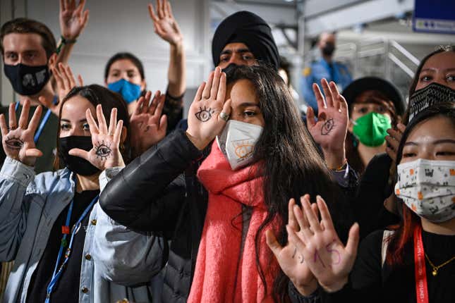 Protesters, young enough to have to live through the consequences of climate change, protest outside COP26