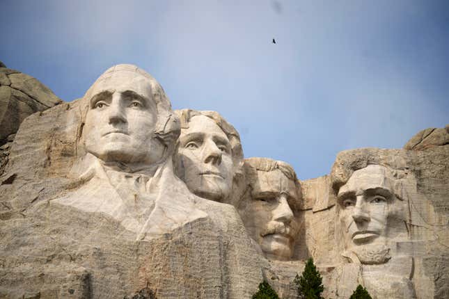 FILE -Visitors take in the massive sculpture carved into Mount Rushmore at the Mount Rushmore National Memorial Thursday, Sept. 21, 2023, in, Keystone, S.D. Fewer planes and helicopters will be flying tourists over Mount Rushmore and other national monuments and parks as new regulations take effect that are intended to protect the serenity of some of the nation&#39;s most beloved natural areas.(AP Photo/David Zalubowski, File)