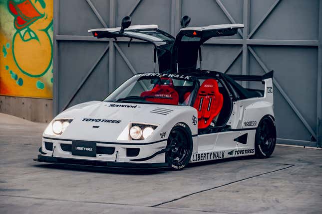 Front 3/4 view of a white Autozam AZ-1 with a Ferrari F40 bodykit and the doors open