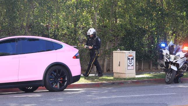 Addison Rae in her pink Tesla Model S gets pulled over by a police officer on a motorcycle 