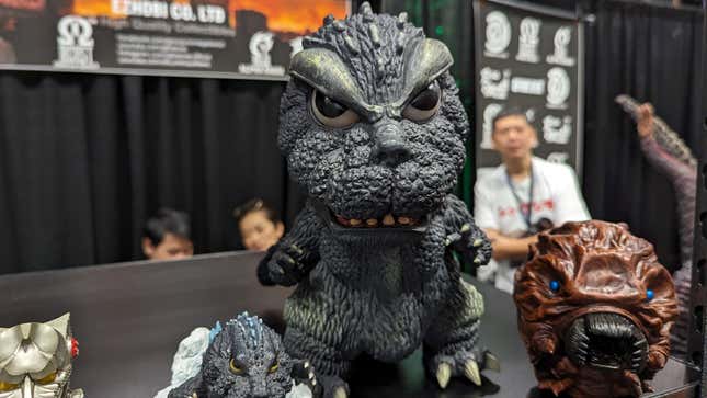 A cute Godzilla statue sits on display.