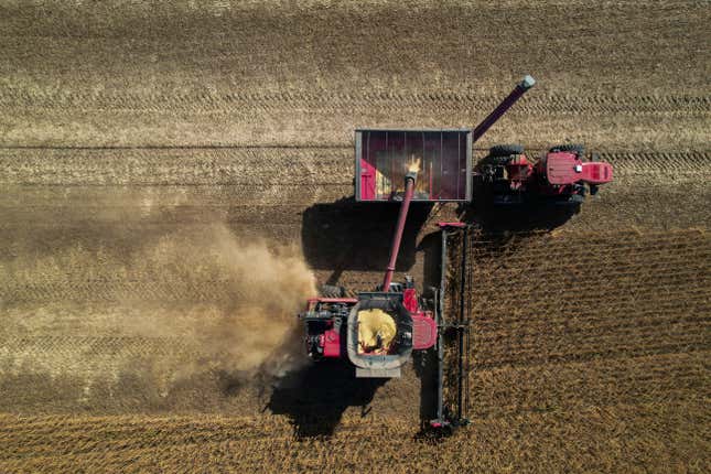 FILE - A combine, bottom, unloads grain into a wagon, top, while harvesting soybeans, Oct. 10, 2023, at a farm near Allerton, Ill. On Wednesday, the Labor Department releases producer prices data for November. The producer price index is an indicator measuring inflation at the wholesale level, hitting businesses before they pass costs along to consumers. (AP Photo/Joshua A. Bickel, File)