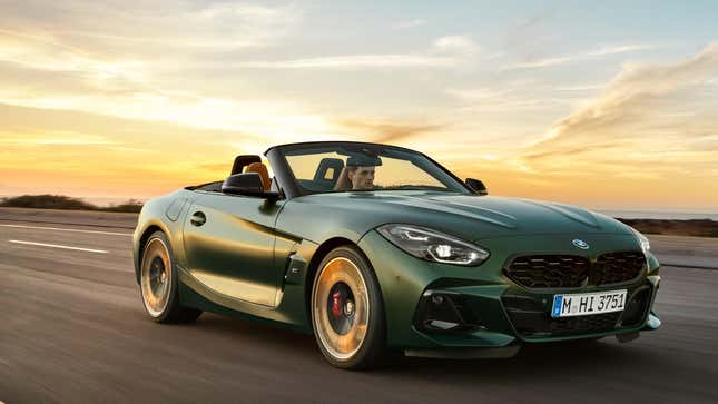 A green BMW Z4 driving with the top down