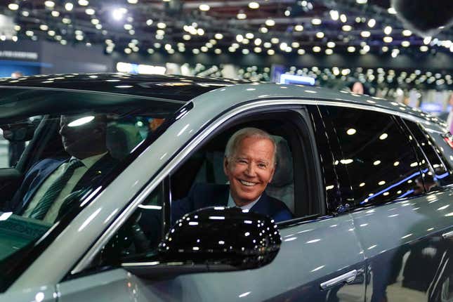 FILE - President Joe Biden drives a Cadillac Lyriq through the show room during a tour at the Detroit Auto Show, Sept. 14, 2022, in Detroit. The Biden administration has proposed new rules that could make it harder for electric vehicles to qualify for a full $7,500 federal tax credit. The rules announced Dec. 1 could complicate efforts to meet President Joe Biden&#39;s goal that half of new passenger vehicles sold in the U.S. run on electricity by 2030. (AP Photo/Evan Vucci, File)