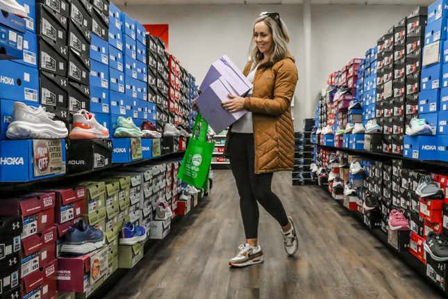 FILE - Ashley Crafton looks at tennis shoes at Shoe Stop in Wesleyan Park Plaza on Nov. 25, 2023, in Owensboro, Ky. About 40% of small business owners think 2024 will be a &quot;make or break&quot; year for their business, according to a survey by messaging service Slack.(Greg Eans/The Messenger-Inquirer via AP, File)