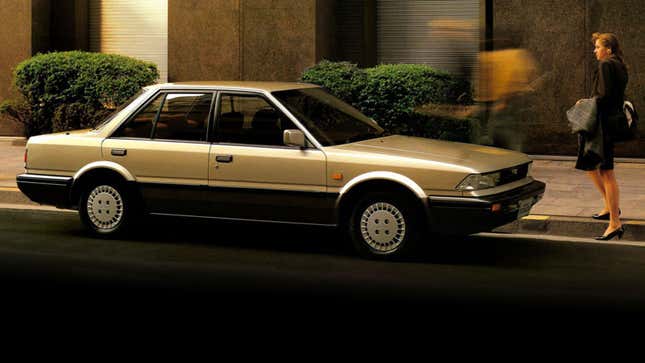 A silver and black Nissan Stanza. 