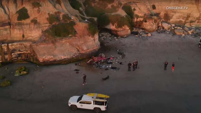 A screenshot of a news report showing the remains of a car at the bottom of a cliff. 