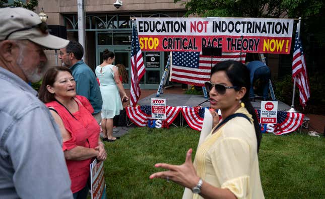 People talk before the start of a rally against “critical race theory” (CRT) being taught in schools at the Loudoun County Government center in Leesburg, Virginia on June 12, 2021. Several states, including Tennessee, have outlawed teaching CRT in schools despite the fact that almost no public school does.