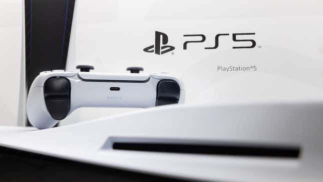 A PlayStation 5 looms ahead of a PS5 controller and PS5 box.