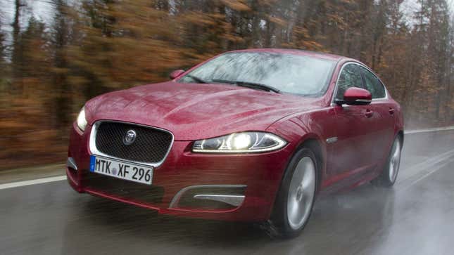 A photo of a red Jaguar XF sedan. 