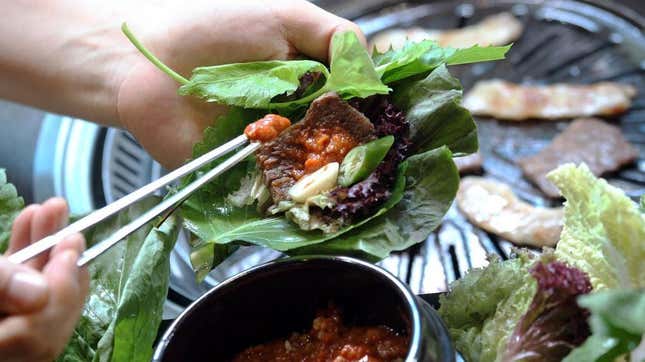 hand holding lettuce wrap