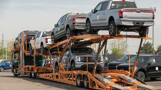 Ford F-150 Lightnings loaded on a delivery truck