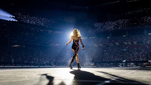 A photo of Taylor Swift walking down her stage at the Eras Tour. 