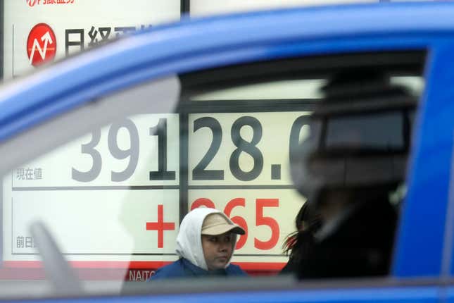 A person stands in front of an electronic stock board showing Japan&#39;s Nikkei 225 index at a securities firm Thursday, Feb. 22, 2024, in Tokyo. Japan’s benchmark Nikkei 225 index surged Thursday past the record it set in 1989 before its financial bubble burst, ushering in an era of faltering growth. (AP Photo/Eugene Hoshiko)