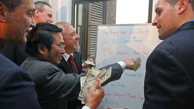 Executives place bets on the guy with dreadlocks and his girlfriend.