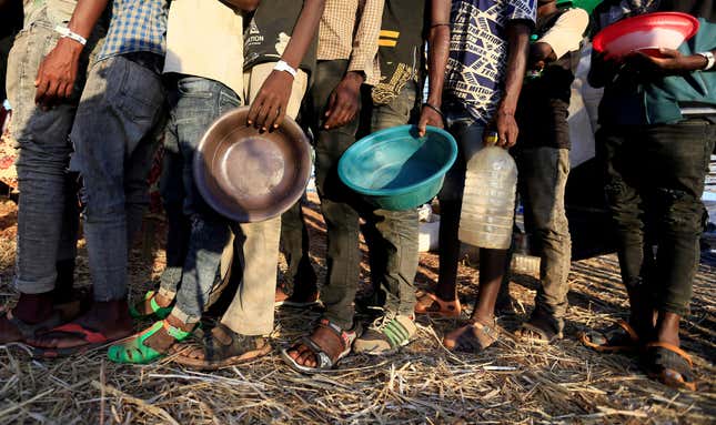 Ethiopian refugees who fled Tigray region, queue to receive food aid within the Um-Rakoba camp in Al-Qadarif state, on the border, in Sudan