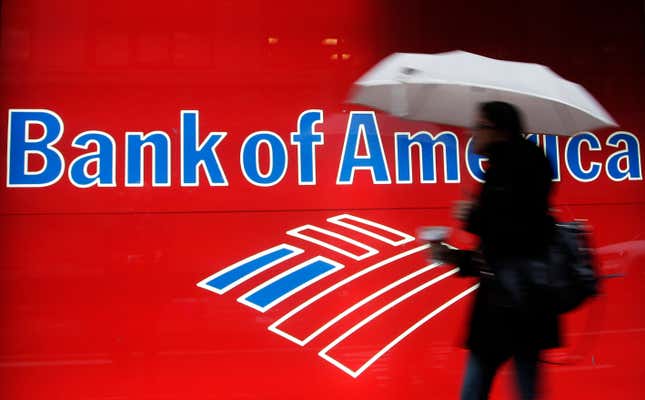 FILE - In this Dec. 7, 2012 photo, a woman passes a Bank of America office branch, in New York. Bank of America reports earnings on Tuesday, Oct. 17, 2023. (AP Photo/Mark Lennihan, File)