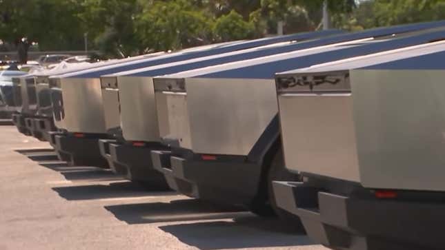 A photo of the rear ends of six Cybertruck EVs. 