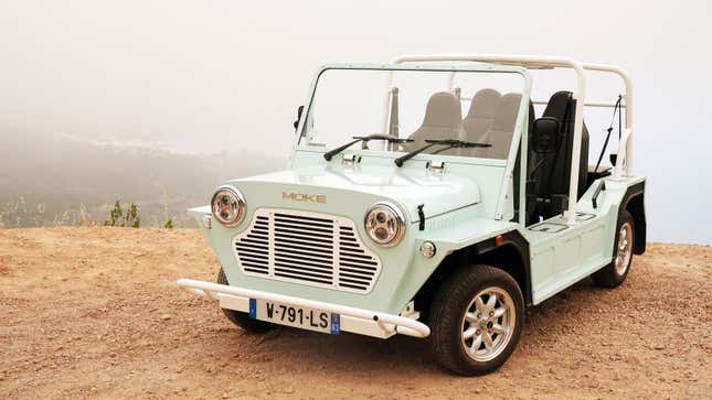 A photo of a Moke Californian EV on a cliff. 