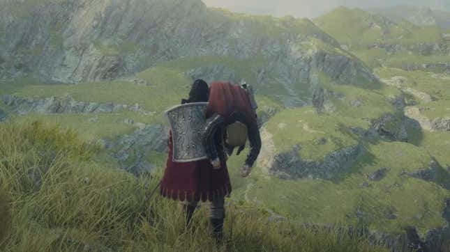 A knight holding a man over his shoulder while overlooking a cliff