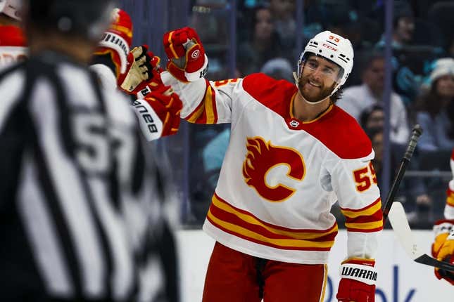 Nov 4, 2023; Seattle, Washington, USA; Calgary Flames defenseman Noah Hanifin (55) celebrates after scoring a goal against the Seattle Kraken during the second period at Climate Pledge Arena.