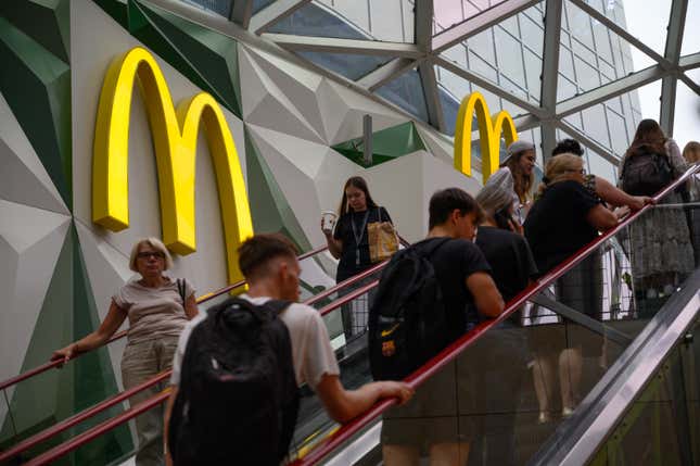 People using an escalator leading to a McDonald’s in a shopping mall in Warsaw, Poland. 