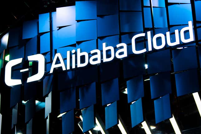 logo sits illuminated outside the Alibaba Cloud booth