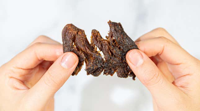 Mushroom jerky being torn apart to show texture