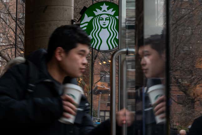 People exit a Starbucks in New York City. 