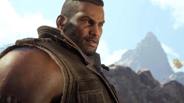 Barret looks off camera while there are mountains behind him.