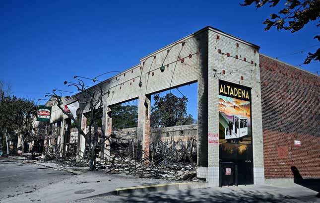 The burnt remains of a building where once stood a hardware store are seen in Altadena, California on January 15, 2025. The historic community of Altadena, on the foothills of the San Gabriel Mountains, has been left in ashes and rubble though some homes remain standing. Powerful winds forecast for Wednesday threatened to whip up massive fires still burning around Los Angeles, possibly worsening an inferno that has killed at least 25 people. 