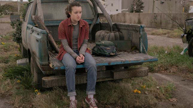 Ellie is seen sitting the back of a truck, seemingly lost in thought.