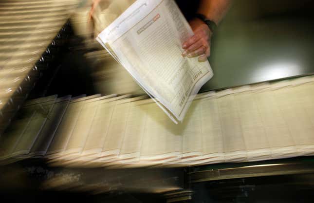 FILE - A pressman pulls a copy of one of the final editions of the Rocky Mountain News off the press in the Washington Street Printing Plant of the Denver Newspaper Agency in Denver on Feb. 26, 2009. The decline of local news in the United States is speeding up despite attention paid to the issue, to the point where the nation has lost one-third of its newspapers and two-thirds of its newspaper journalists since 2005. (AP Photo/David Zalubowski, File)