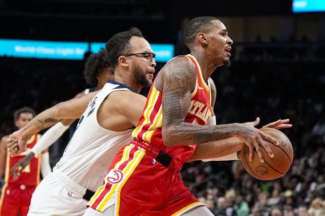 Oct 30, 2023; Atlanta, Georgia, USA; Atlanta Hawks guard Dejounte Murray (5) dribbles past Minnesota Timberwolves forward Kyle Anderson (1) during the second half at State Farm Arena.