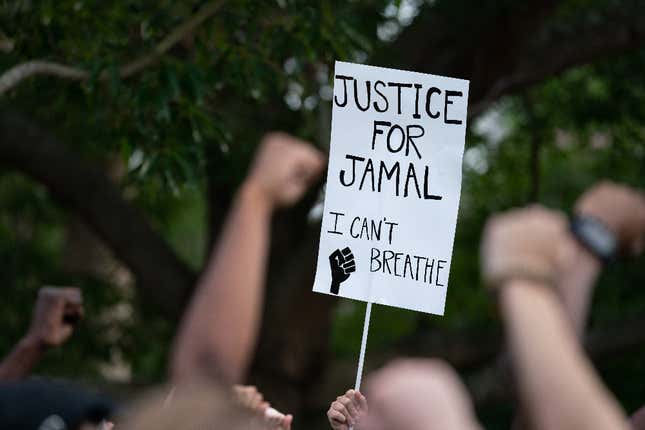 Protestors raise their fists, calling for justice for Jamal Sutherland at Marion Square on May 17, 2021, in Charleston, South Carolina. Sutherland, a black man suffering from mental illness, died after Charleston County deputies shocked him with a stun gun when removing him from a jail cell. Activists want charges brought against the deputies. 