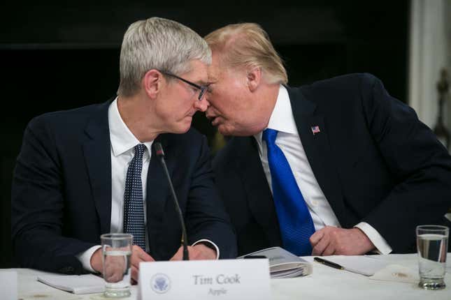 Apple CEO Tim Cook and President Donald Trump chat at an American Workforce Policy Advisory board meeting in March 2019, during the president’s first term in office. 