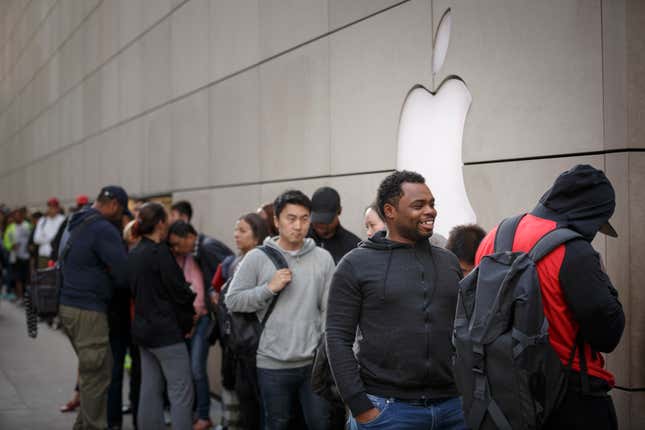 Customers wait in line at the Apple store in Chicago, Illinois.