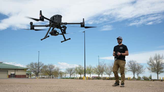 A photo of a police officer flying a drone. 