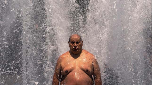 Pablo Miranda cools off in the Salmon Springs Fountain on June 27, 2021, in Portland, Oregon. Record-breaking temperatures lingered over the Northwest during a historic heatwave this weekend. 
