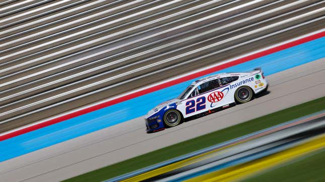 a photo of the AAA nascar mustang driving on the track with everything else blurred