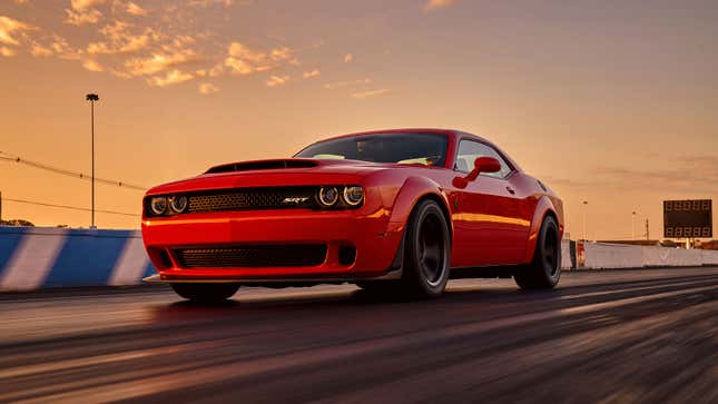 A photo of a red Dodge Demon on a race track. 