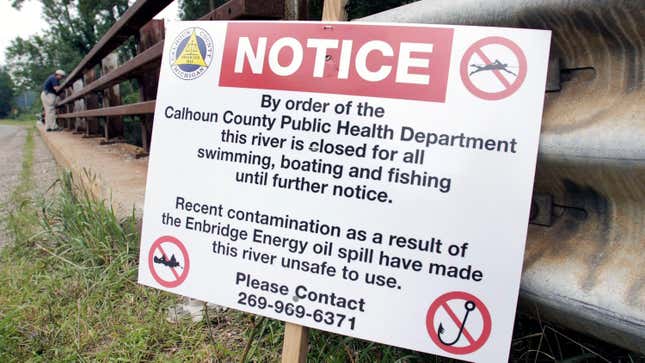  A sign is posted on a bridge to indicate water contamination after an oil spill of approximately 800,000 gallons of crude in the Kalamazoo River July 28, 2010 in Marshall, Michigan. A 30 inch-wide underground pipeline owned by Calgary, Alberta-based Enbridge Energy Partners LP, began leaking on June 26. 