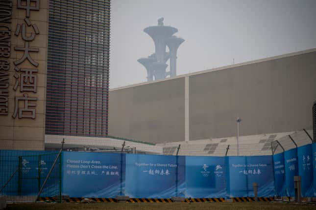 The Olympic Tower is seen behind a a barricade that delimitates the area not accessible to the general public, that will host Beijing 2022 Winter Olympics at Olympic Park on January 23, 2022 in Beijing, China.