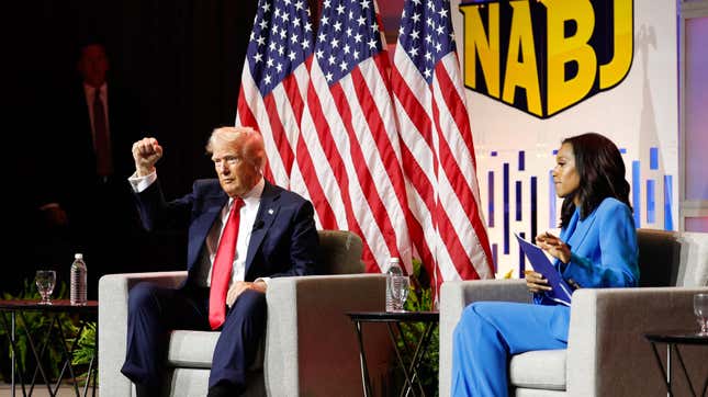 Former U.S. President and 2024 Republican nominee Donald Trump gestures at the conclusion of a political forum as moderator and journalist Rachel Scott looks on during the National Association of Black Journalists annual convention in Chicago on July 31, 2024.