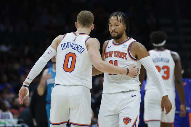 Nov 18, 2023; Charlotte, North Carolina, USA; New York Knicks guard Jalen Brunson (11) embraces guard Donte DiVincenzo (0) during the first quarter against the Charlotte Hornets at Spectrum Center.