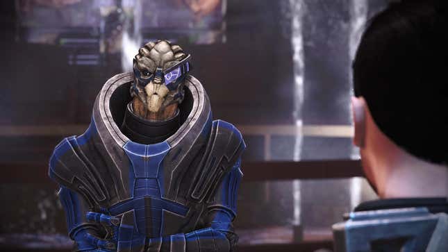 Garrus is seen speaking to Shepard in the Citadel tower, with a fountain in the background.