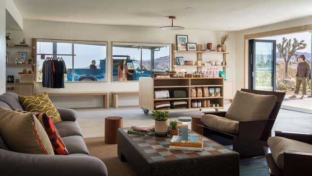 A photo of the charging outpost's interior showing a couch and chairs and books