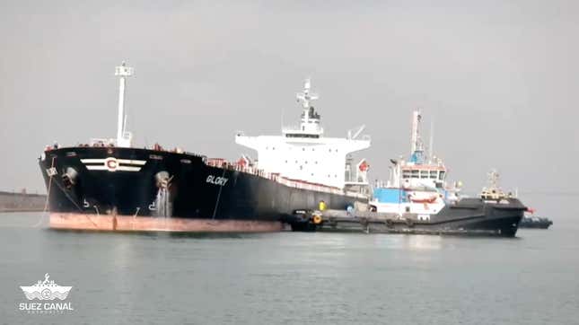 The Glory being helped though the Suez Canal by tugboats.